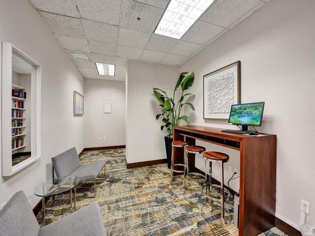 office area with a paneled ceiling