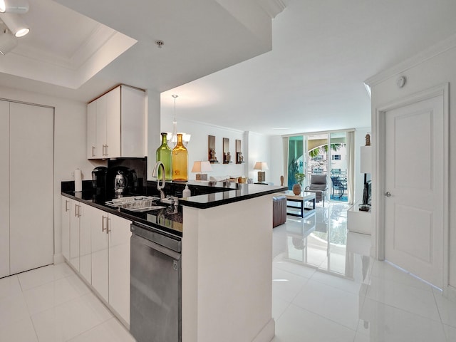 kitchen with a peninsula, a tray ceiling, ornamental molding, dishwasher, and dark countertops