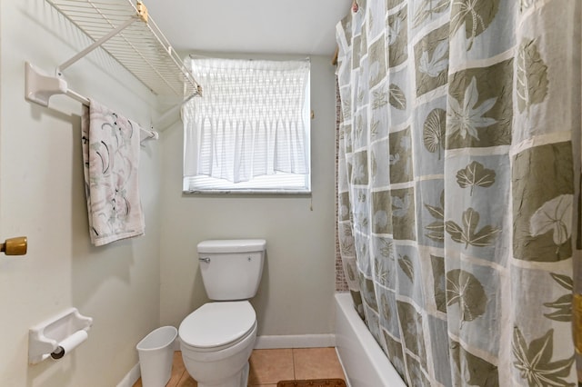 bathroom featuring toilet, tile patterned floors, and shower / tub combo with curtain