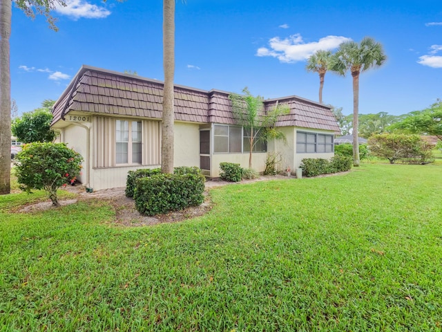 rear view of house with a lawn