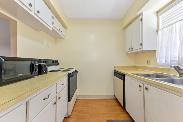 kitchen with white cabinetry, sink, electric range, and stainless steel dishwasher