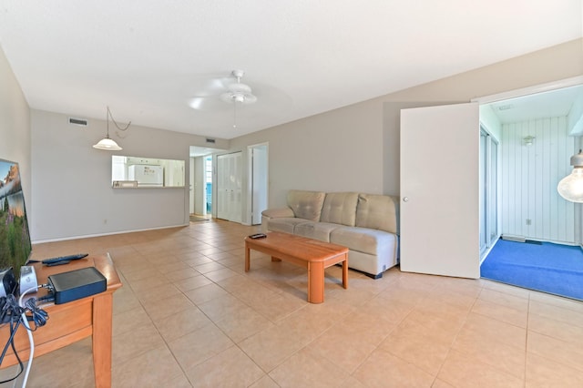 tiled living room with ceiling fan