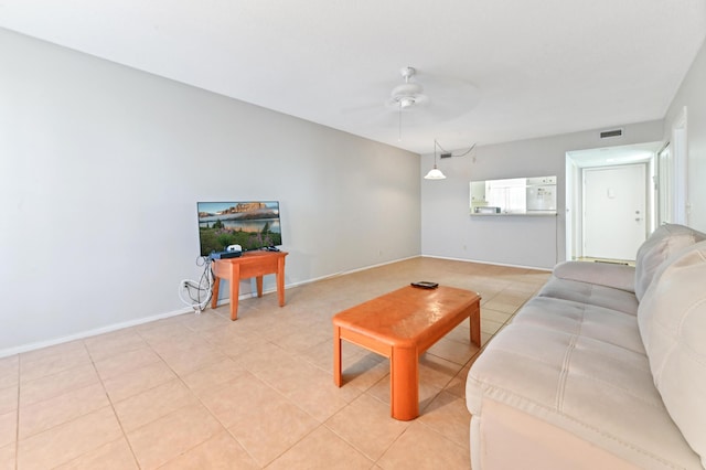 living room featuring ceiling fan and light tile patterned floors