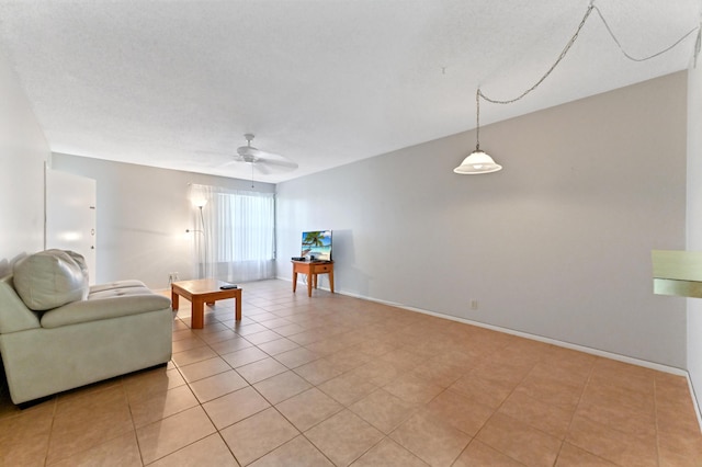 living room with ceiling fan and light tile patterned floors