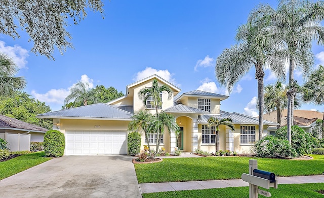 view of front of home featuring a front lawn and a garage