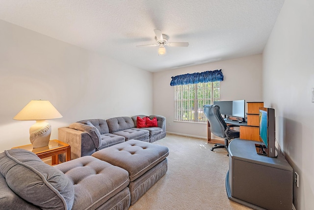 interior space featuring ceiling fan, light colored carpet, and a textured ceiling