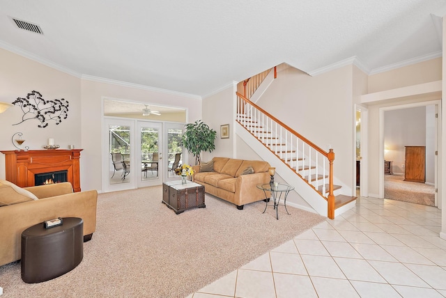 living room with carpet floors, ceiling fan, ornamental molding, and french doors