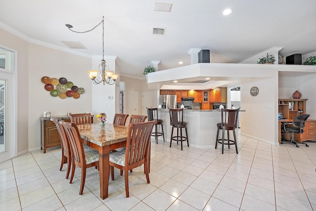 dining area featuring a notable chandelier, light tile patterned floors, and ornamental molding