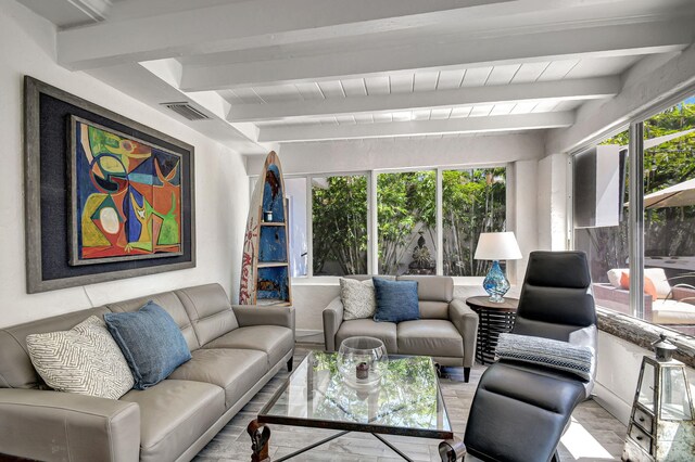 sunroom / solarium featuring beamed ceiling