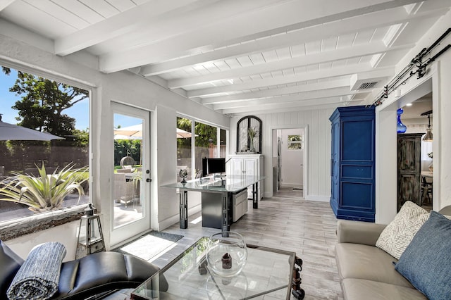 interior space featuring beam ceiling and light hardwood / wood-style floors