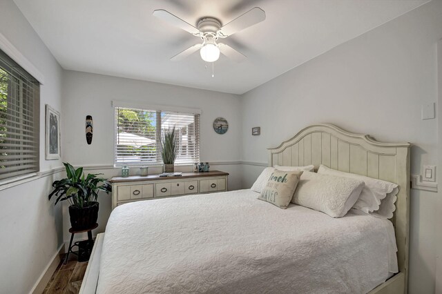 bedroom with ceiling fan, hardwood / wood-style flooring, and a barn door