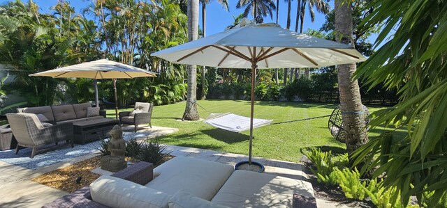 back of house featuring a patio, a lawn, and an outdoor hangout area