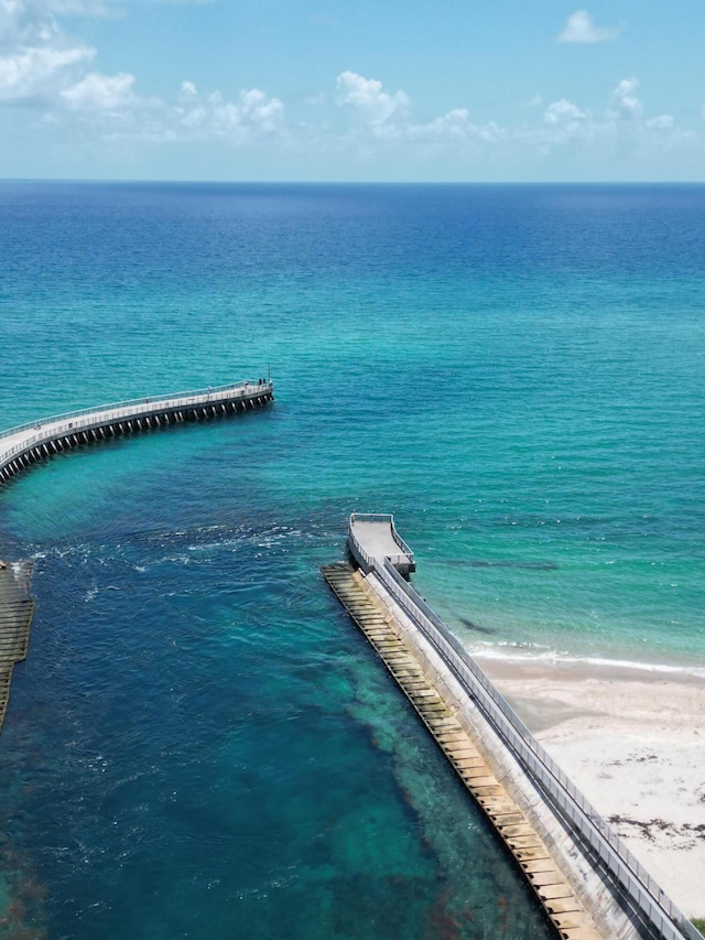 drone / aerial view with a water view and a beach view