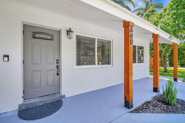 doorway to property featuring a porch