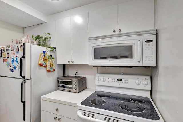 kitchen with white appliances and white cabinetry