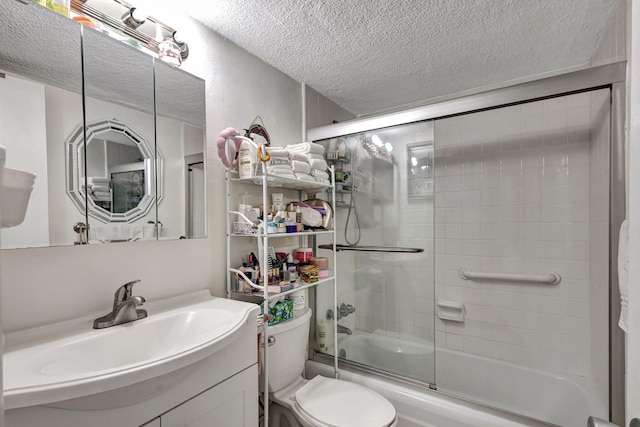 full bathroom with vanity, toilet, a textured ceiling, and bath / shower combo with glass door