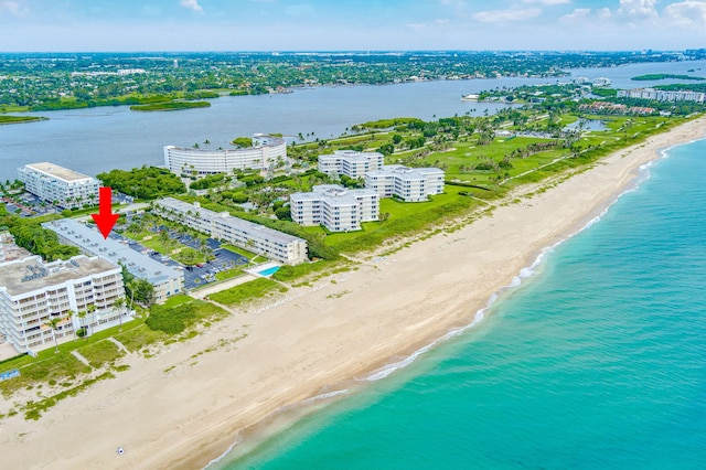 birds eye view of property featuring a view of the beach and a water view