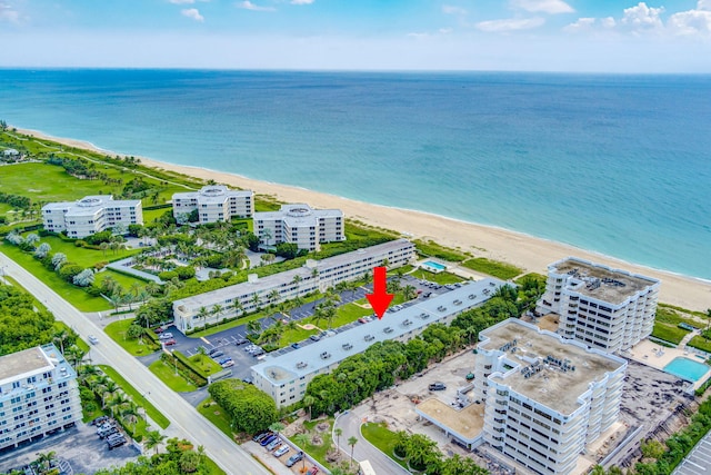 drone / aerial view with a water view and a view of the beach