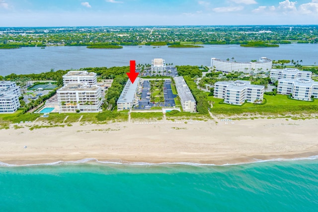 birds eye view of property featuring a beach view and a water view