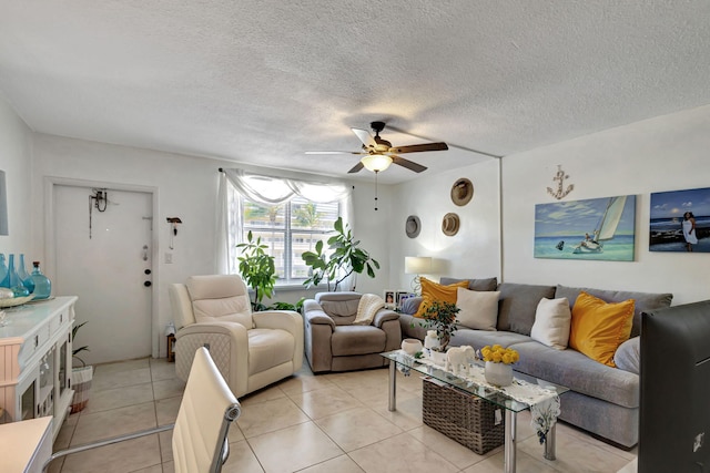 living room with a textured ceiling, ceiling fan, and light tile patterned floors