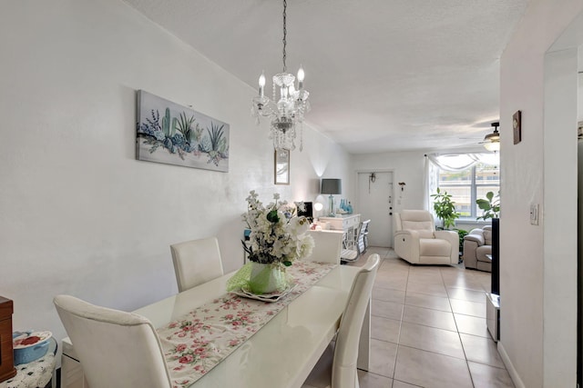 dining room featuring ceiling fan with notable chandelier and light tile patterned floors