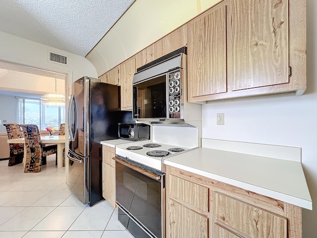 kitchen with light brown cabinets, white electric range oven, a chandelier, light tile patterned floors, and a textured ceiling