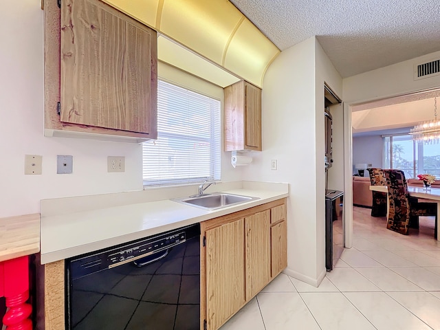 kitchen with plenty of natural light, visible vents, dishwasher, light countertops, and a sink