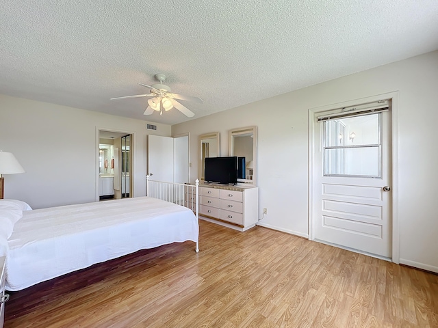 unfurnished bedroom featuring light wood-style flooring, visible vents, and a textured ceiling