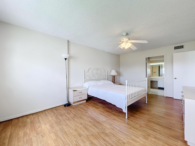 unfurnished bedroom with a textured ceiling, ceiling fan, light wood finished floors, and visible vents