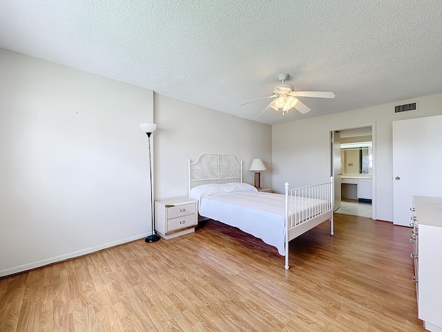 unfurnished bedroom featuring a textured ceiling, ceiling fan, and light wood-type flooring