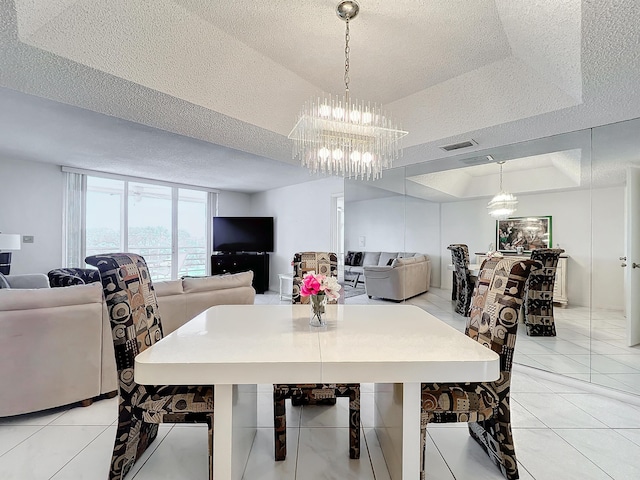 dining room featuring a raised ceiling, visible vents, a textured ceiling, and light tile patterned flooring