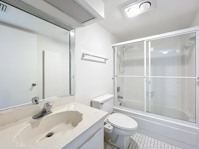 full bathroom featuring tile patterned flooring, shower / bath combination with glass door, toilet, and vanity