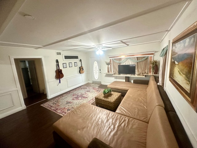 living room with ceiling fan and dark hardwood / wood-style flooring