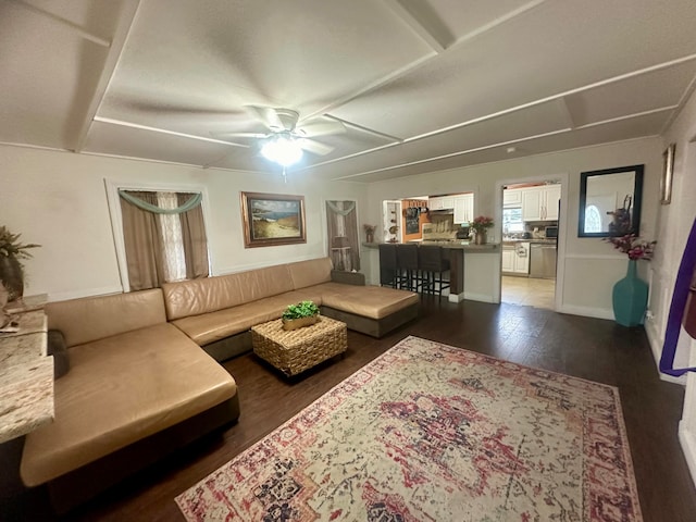 living room featuring dark tile patterned flooring and ceiling fan