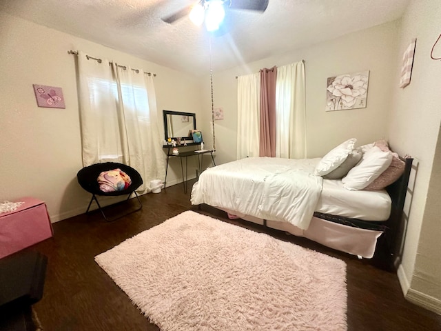 bedroom featuring ceiling fan and dark wood-type flooring