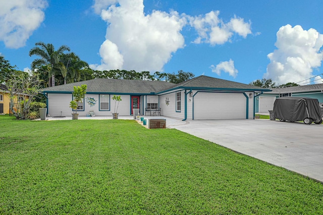 ranch-style house featuring a garage and a front lawn