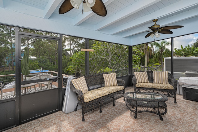 sunroom / solarium featuring beamed ceiling and ceiling fan