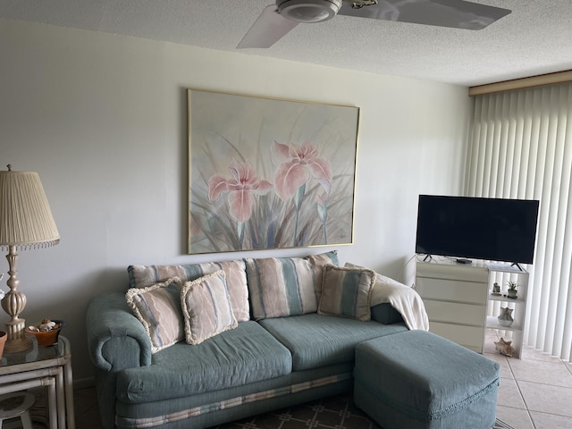 tiled living room with a textured ceiling and ceiling fan