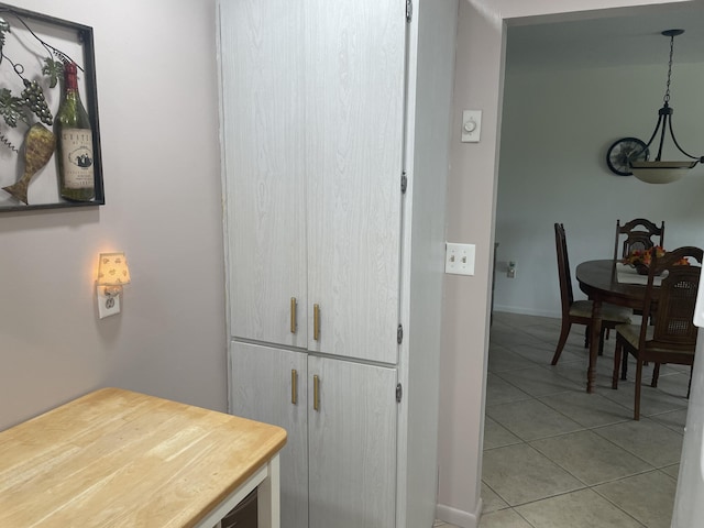 interior space featuring baseboards and light tile patterned floors