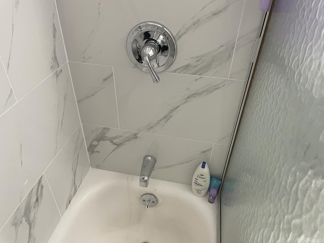 interior details with a tub to relax in and a shower