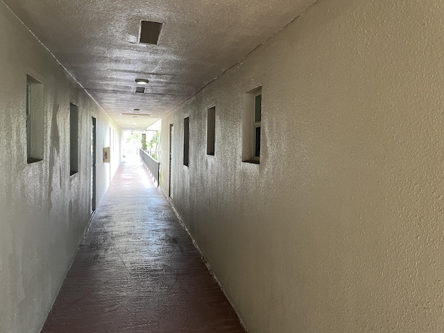 hallway featuring a textured wall