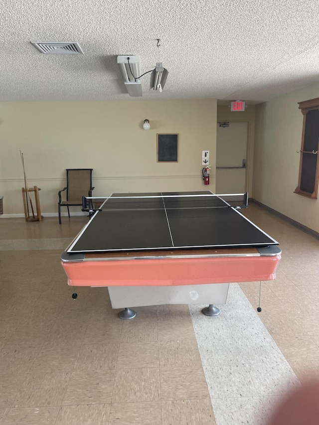 game room with visible vents, a textured ceiling, and baseboards