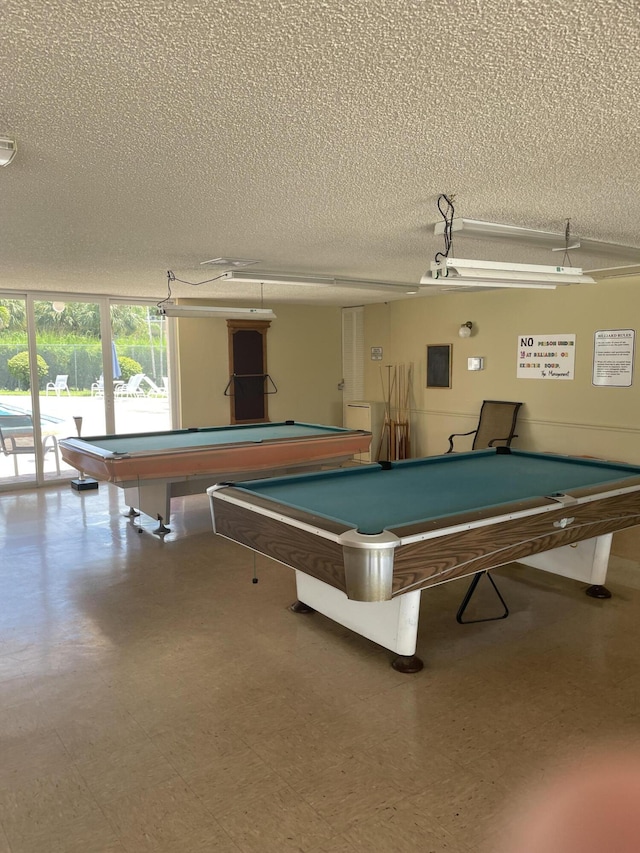 rec room with pool table, a textured ceiling, and tile patterned floors