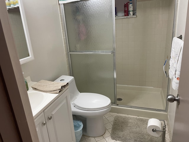 bathroom with a stall shower, tile patterned flooring, vanity, and toilet