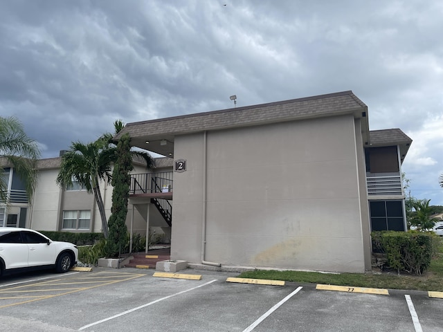 view of building exterior with uncovered parking