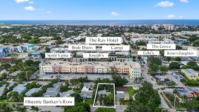 birds eye view of property featuring a view of city and a water view