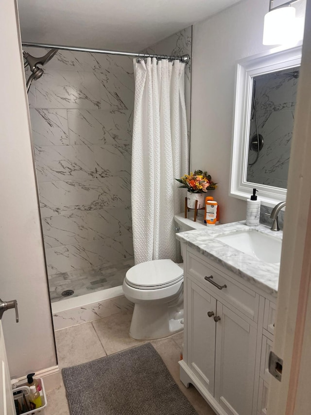 bathroom featuring tile patterned floors, toilet, vanity, and a shower with shower curtain