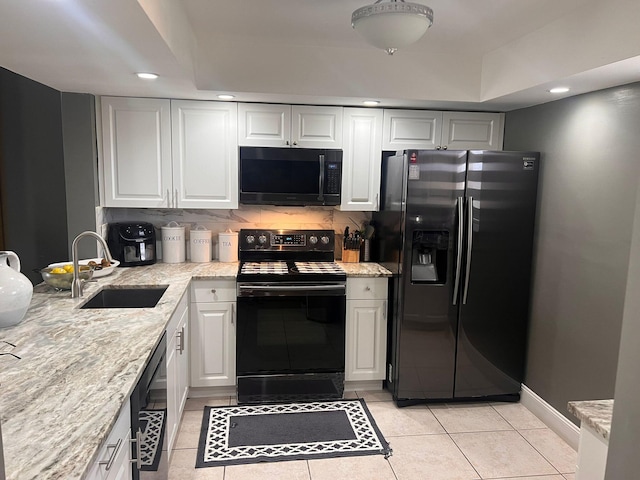 kitchen with backsplash, white cabinetry, sink, black appliances, and light tile patterned flooring