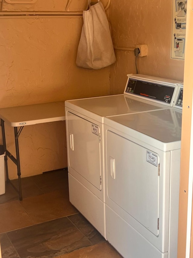 washroom featuring dark hardwood / wood-style floors and washer and clothes dryer