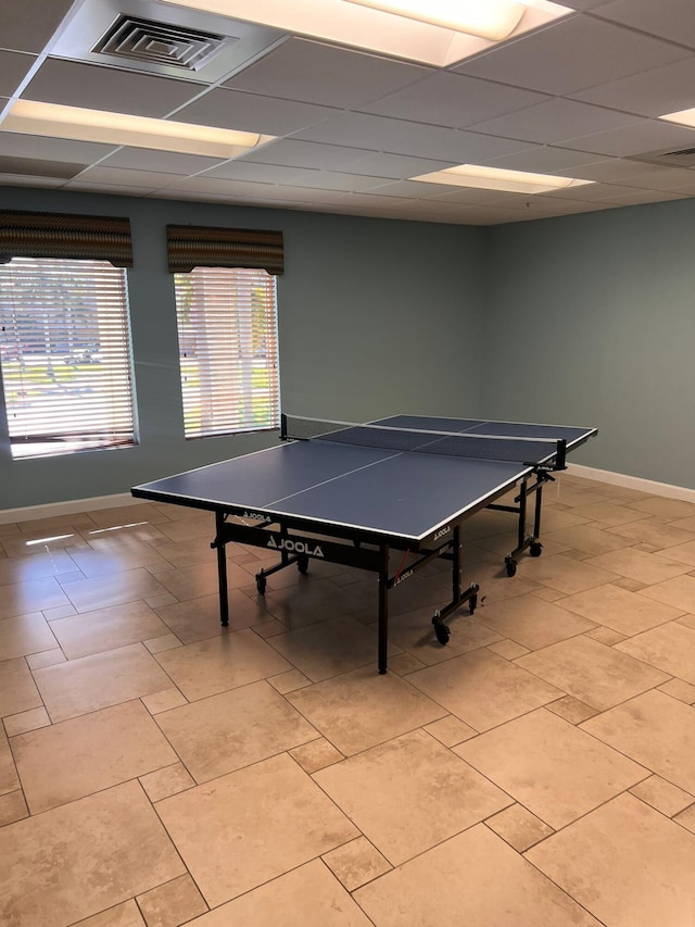 rec room featuring a drop ceiling and light tile patterned floors